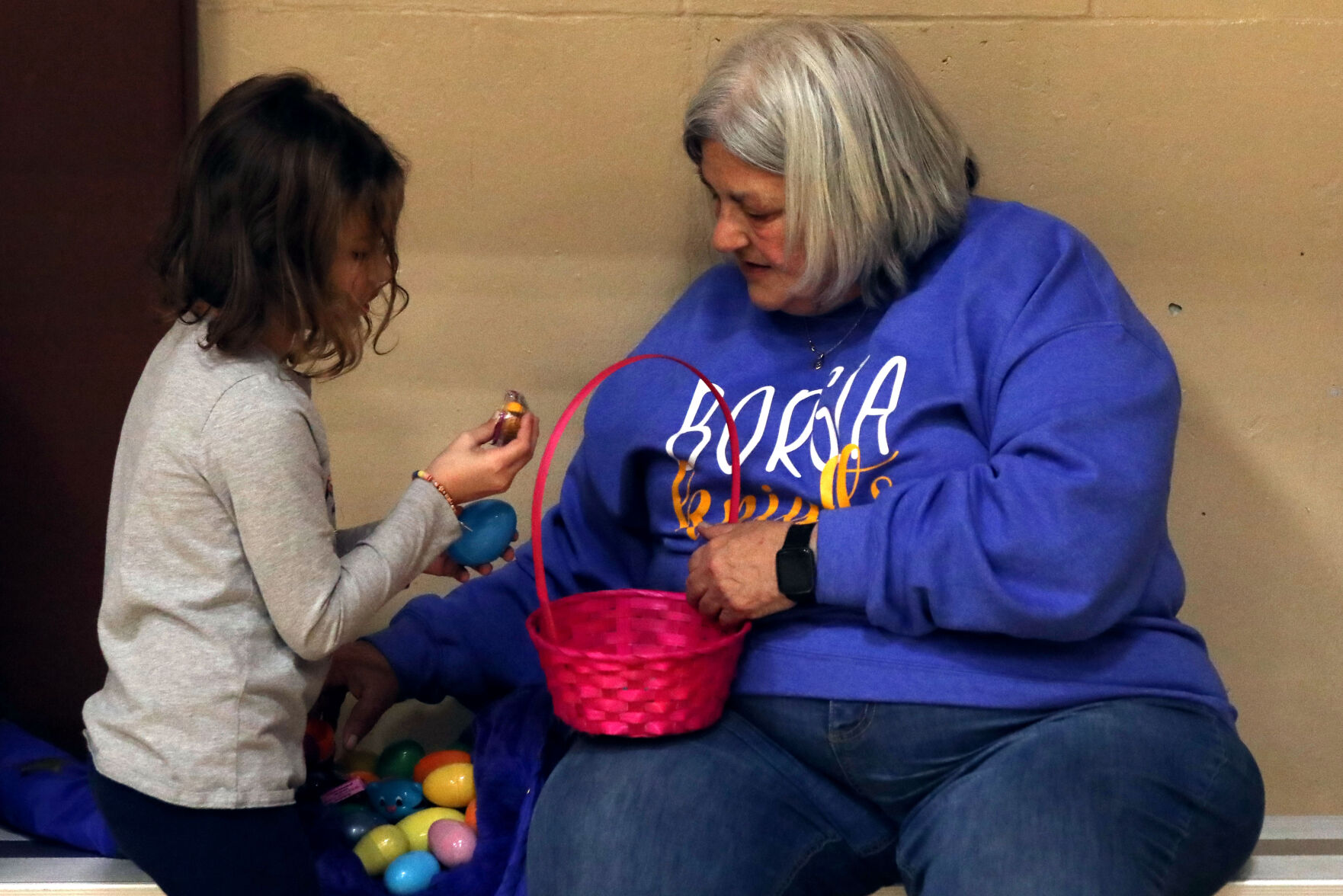 Sophia and Liz Massey crack open eggs